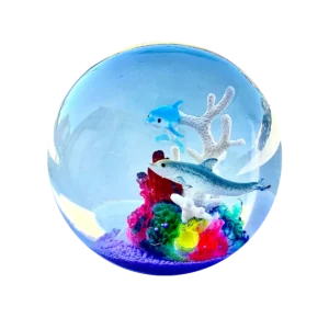 An image of the ocean squishy Kiedle stress ball with dolphins over a transparent background