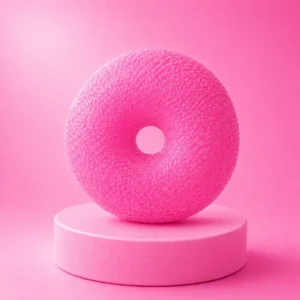 An image of the pink donut squishy Kiedle stress ball over a pink background